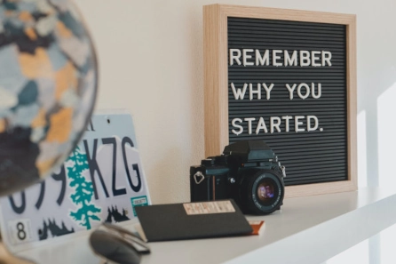 Motivational display with the quote 'Remember Why You Started,' symbolizing the unbiased and objective perspective coaches bring to challenge limiting beliefs and inspire real connections.